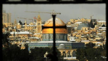 The Dome of the Rock Mosque is seen covered with snow through the window of the Church of Dominus Flevit outside Jerusalem's Old City, Thursday, Jan. 31, 2008. AP