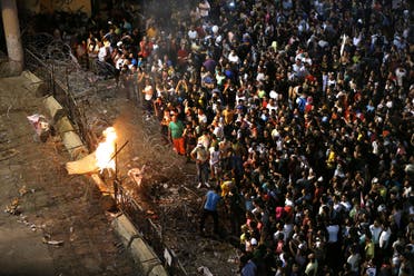 Lebanese anti-government protesters burn a mattress on a barbed wire barrier that blocks the road to the government building, during a demonstration in downtown Beirut, Lebanon, Saturday, Aug. 29, 2015.  (AP)