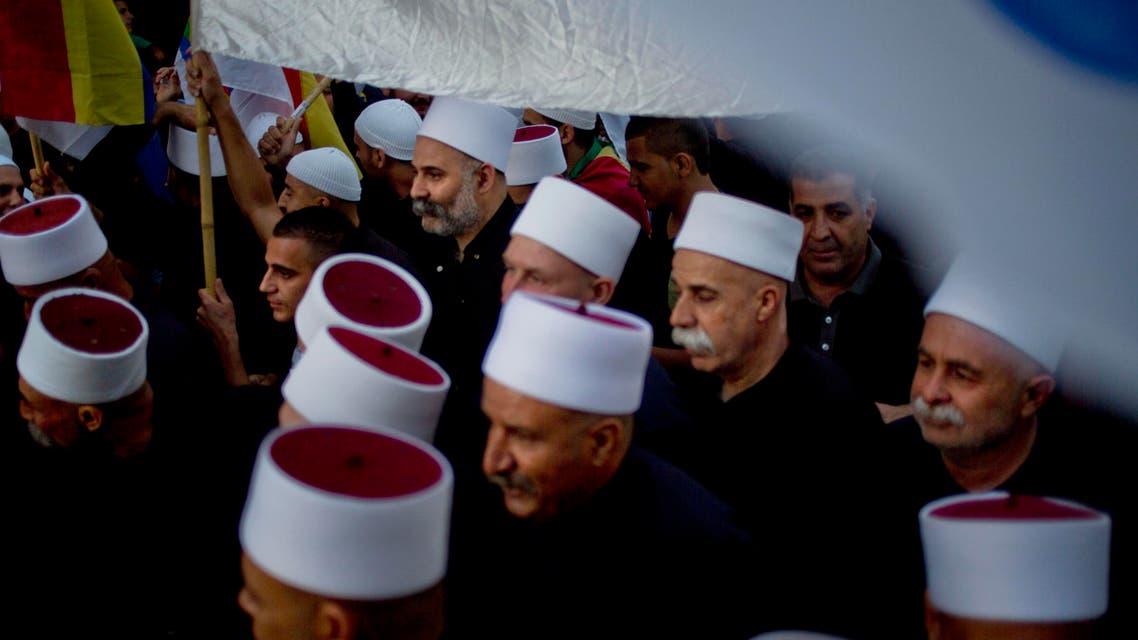 On Sunday, June 14, 2015, members of Israel's Druze minority wave their flags during a march in the Druze village of Yarka, Israel. (AP)