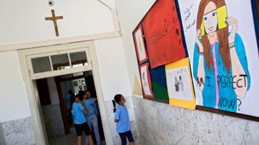  In this photo taken Tuesday, May 26, 2015, An Arab Israeli Christian school girl looks at a board with drawings at the Terra Santa School in the mixed Jewish-Arab city of Ramle, Israel. Private Christian schools are among Israel’s highest ranked educational institutions, established by churches in the Holy Land hundreds of years ago long before Israel was established. But school administrators are accusing Israel of slashing their funding as a pressure tactic to get them join the Israeli public school system a move they say would interfere with the schools’ Christian values and high academic achievements. (AP Photo/Oded Balilty)