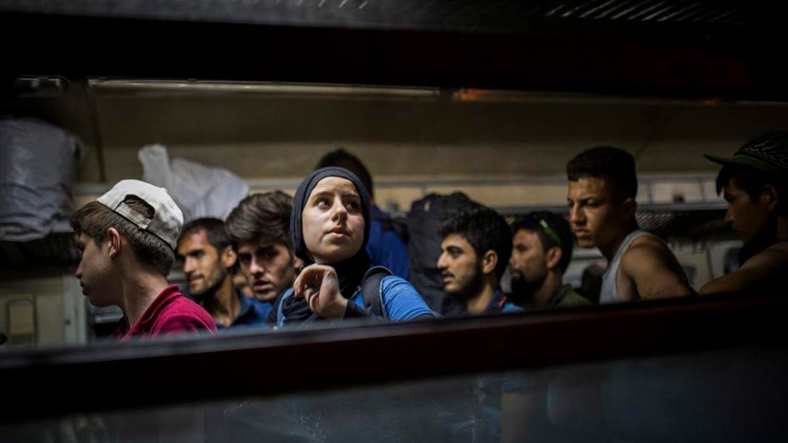 Refugees get off a train at the Macedonian station of Tabanovce, a few hundred meters away from the border with Serbia, on Friday Aug. 28, 2015. (AP)