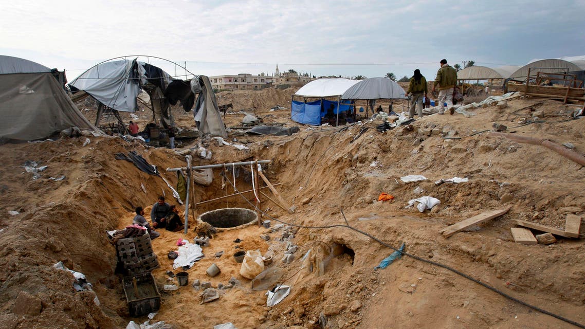 Palestinian workers rebuild a destroyed smuggling tunnel area along the Egypt Gaza border in Rafah, southern Gaza Strip.(AP)