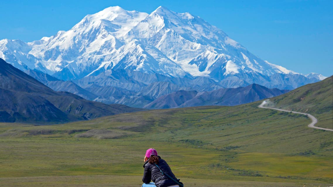 In this Monday, Aug. 3, 2015, photo provided by Holland America Line, a woman gazes at Mount McKinley in Denali National Park and Preserve in Alaska. (AP)