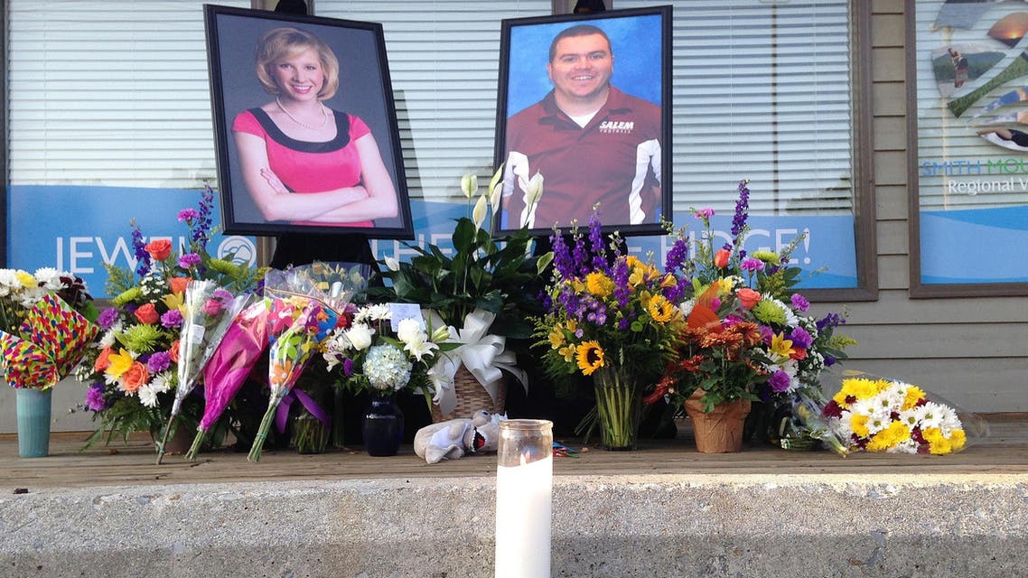 A candle burns in front of a memorial for two slain journalists at Bridgewater Plaza in Moneta, Virginia on Friday, August 28, 2015.