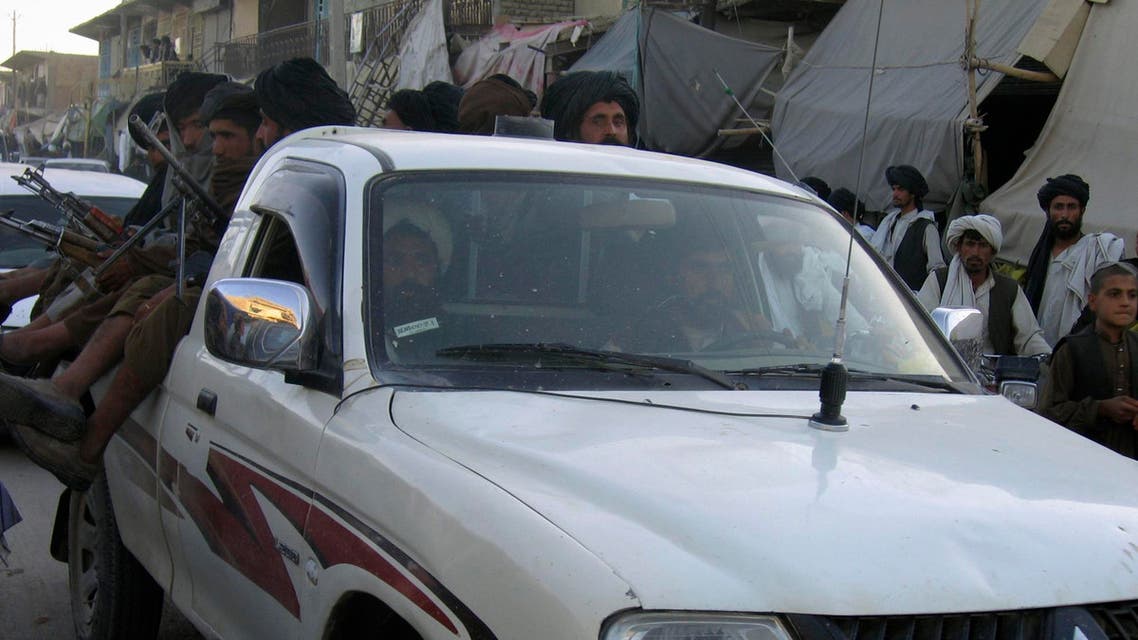 Taliban militants sit on a vehicle as they pass a bazaar in the Musa Qala district of Helmand province, south of Kabul, Afghanistan Nov. 20, 2007. Taliban militants have held Musa Qala since February, but NATO and Afghan troops have stepped up operations there in recent weeks and appear poised to take back the town from the hundreds of Taliban and foreign fighters who have controlled it this year. Musa Qala is in northern Helmand province, the world's largest poppy growing region. (AP Photo )