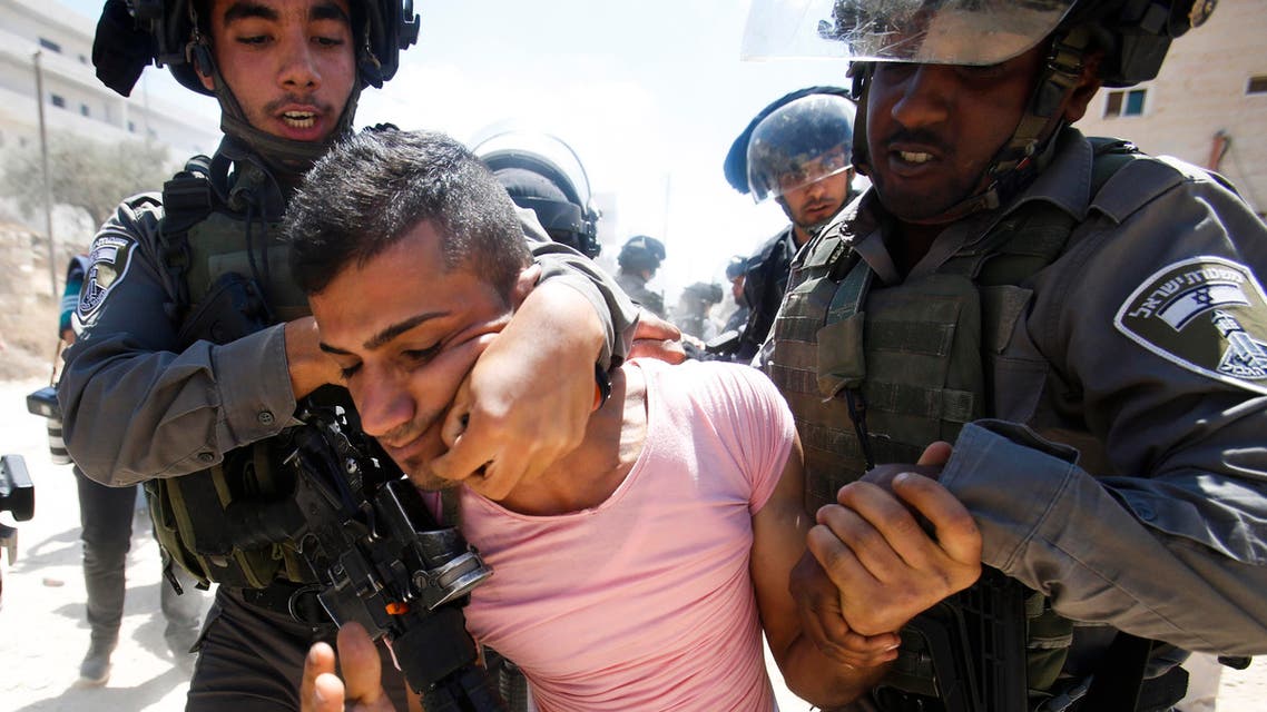 Israeli border police detain a Palestinian during a protest against the Israeli separation barrier, in Beit Jala, West Bank, Sunday, Aug. 30. (File photo: AP)