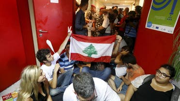 Protestors carry a Lebanese flag inside the environment ministry in downtown Beirut, Lebanon September 1, 2015. REUTERS