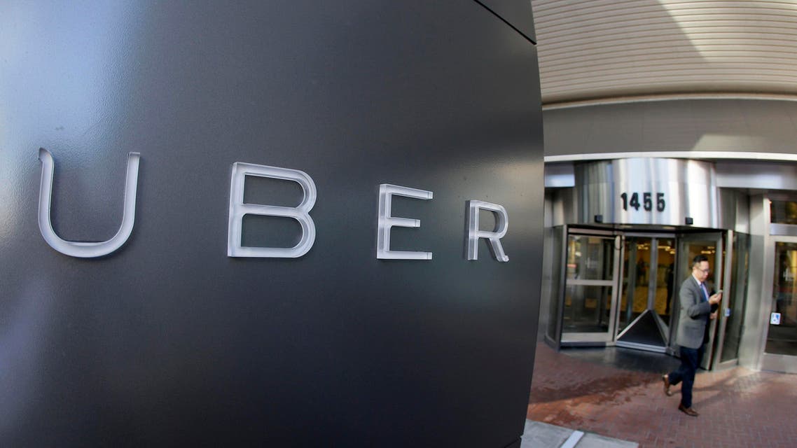  In this Dec. 16, 2014, file photo a man leaves the headquarters of Uber in San Francisco. Uber, Lyft and other ride-hailing companies may soon be able to pick up passengers at Los Angeles International Airport after debate over whether their drivers are properly screened to weed out criminals. (AP Photo/Eric Risberg, File)