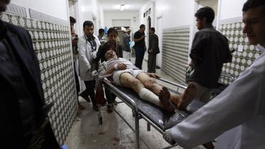  Medics transport an injured Yemeni man on a gurney as he arrives at a hospital in Sanaa after being injured when two suicide bombers hit a Shiite mosque in the Yemeni capital in quick succession on September 2, 2015. AFP