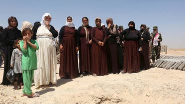Yazidi women, relatives of Yazidis who were killed by militants of the Islamic State, stand near the coffins during a burial ceremony at Mazar Sharaf al-Din, north of Sinjar Mountain, August 13, 2015. (File: Reuters)