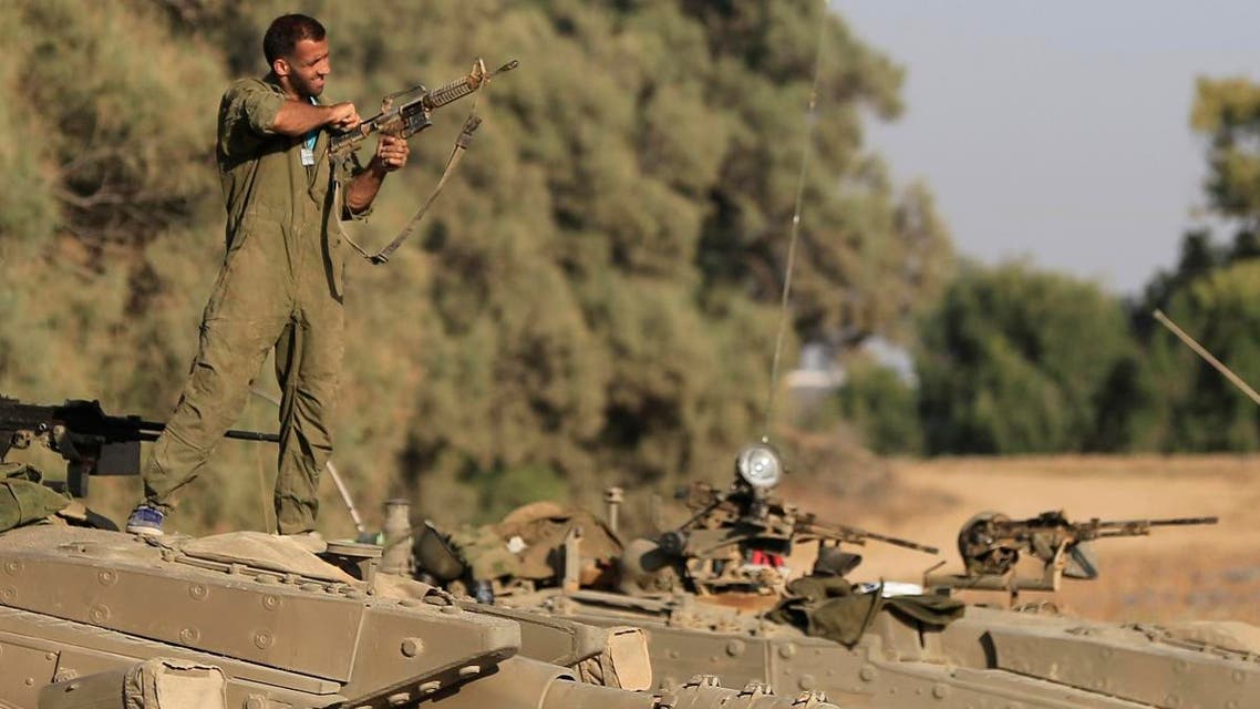 An Israeli soldier checks his weapon near the Israel and Gaza border, Thursday, July 10, 2014. (File photo: AP)