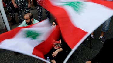Lebanese activists wave national flags and shout slogans outside the interior ministry during a sit-in in Beirut, Lebanon, Thursday, Sept. 3, 2015 (AP)