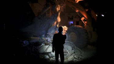 File photo: A resident inspects damage from what activists said was barrel bombs dropped by forces loyal to Syria's President Bashar Al-Assad in Douma, Eastern Al-Ghouta, in August. (Reuters)