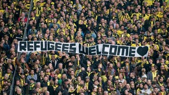 Football fans show support for refugees during matches