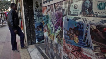 A man walks next to a currency exchange office in downtown Cairo, Egypt, Wednesday, Jan. 2, 2013. ap