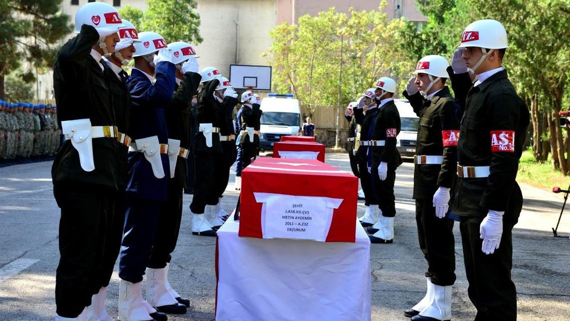 Turkish soldiers salute next to the flag-covered coffins of three soldiers killed during the clashes with Kurdish rebels late Tuesday, during a ceremony in Diyarbakir, Turkey, Wednesday, Aug. 19, 2015. At least eight other soldiers were killed by a roadside bomb detonated by Kurdish rebels in eastern Turkish city of Siirt on Wednesday, Turkish news the agencies said. At least 85 people, most of them police and soldiers, have been killed since July in the renewed violence between the security forces and the Kurdistan Workers' Party, or PKK.(IHA via AP)