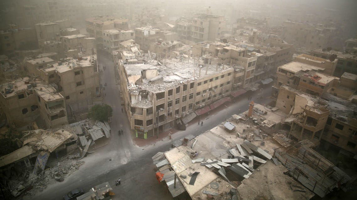 A picture taken on September 7, 2015 shows a general view of damaged buildings in the rebel-held area of Douma, east of the capital Damascus as a sandstorm blows over the city. AFP PHOTO / SAMEER AL-DOUMY