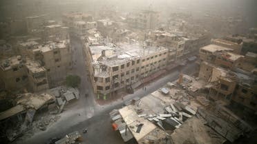 A picture taken on September 7, 2015 shows a general view of damaged buildings in the rebel-held area of Douma, east of the capital Damascus as a sandstorm blows over the city. AFP PHOTO / SAMEER AL-DOUMY    	