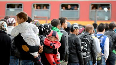  People stand in a queue as they prepare to leave by train from the southern Macedonian town of Gevgelija,Tuesday, Sept. 8, 2015. Hundred of thousands migrants and refugees trying to reach the heart of Europe via Turkey, Greece, the Balkans and Hungary have faced dangers, difficulties and delays on every link of the journey. (AP Photo/Borce Popovski)