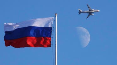 A plane flies over the Russian flag atop the Konstantin Palace in St.Petersburg, Russia, Friday, July 24, 2015. (AP)