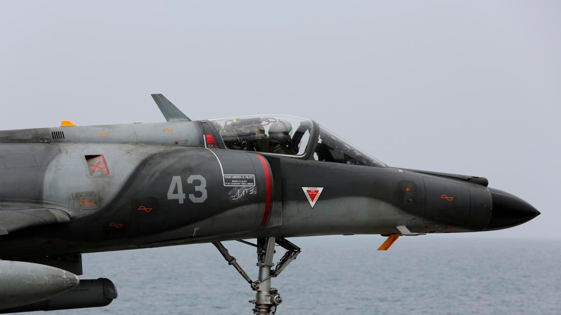 In this photo taken Wednesday, March 18, 2015, a French military plane lands on the French navy aircraft carrier Charles de Gaulle in the Persian Gulf. AP