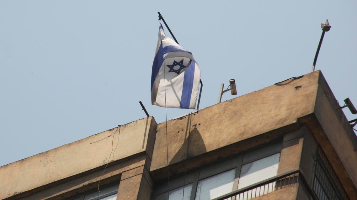 In this image taken Saturday Aug. 20, 2011 shows an Israeli flag flying over the Israeli embassy in Cairo, Egypt, a day before a young Egyptian man managed, at dawn, to climb 15 floors on a high building where the Israeli embassy is located, to remove the Israeli flag from the embassy balcony and replace it with the Egyptian flag. Hundreds of Egyptians protest the deaths of Egyptian security forces killed in a shootout between Israeli soldiers and Palestinian militants on Thursday in the Sinai. Egypt said Saturday it would recall its ambassador from Israel to protest the deaths, sharply escalating tensions between the neighboring countries, whose 1979 peace treaty is being tested by the fall of Egypt's longtime autocratic leader, Hosni Mubarak. (AP Photo/Amr Nabil)