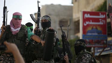 Palestinian Hamas militants take part in a military parade marking the first anniversary of the killing of Hamas's military commanders Mohammed Abu Shammala and Raed al-Attar, in Rafah in the southern Gaza Strip August 21, 2015. Abu Shammala and al-Attar were killed by an Israeli air strike during a 50-day war between the armed group and Israel last summer. REUTERS/Suhaib Salem