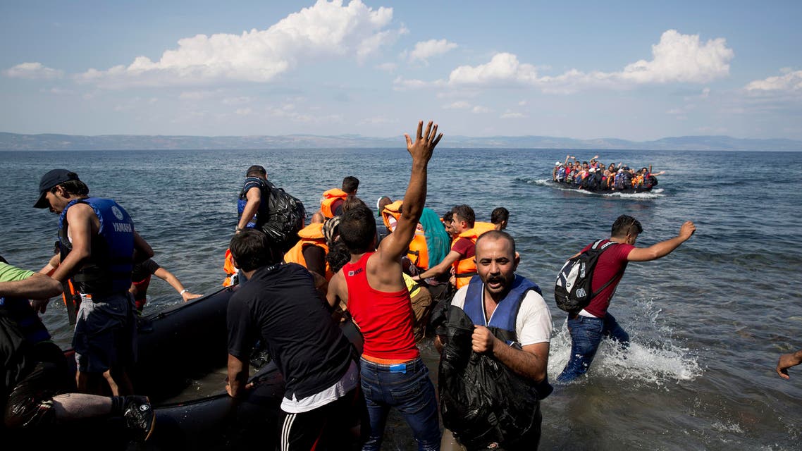  Migrants and refugees arrive on a dinghy after crossing from Turkey to Greece, as another one approaches the coast of Lesbos island, Tuesday, Sept. 8, 2015,.The island of some 100,000 residents has been transformed by the sudden new population of some 20,000 refugees and migrants, mostly from Syria, Iraq and Afghanistan. (AP Photo/Petros Giannakouris)