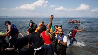  Migrants and refugees arrive on a dinghy after crossing from Turkey to Greece, as another one approaches the coast of Lesbos island, Tuesday, Sept. 8, 2015,.The island of some 100,000 residents has been transformed by the sudden new population of some 20,000 refugees and migrants, mostly from Syria, Iraq and Afghanistan. (AP Photo/Petros Giannakouris)