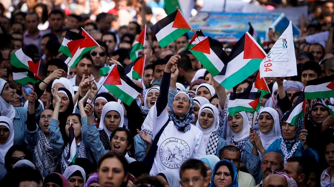 Palestinians wave flags during a rally in support of the Palestinian bid for statehood recognition in the United Nations. (AP)