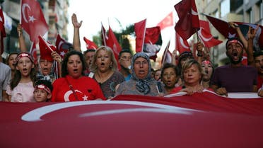 Thousands of people march to protest against the deadly attacks on Turkish troops, in Izmir, Turkey, late Wednesday. (AP)