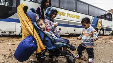 Children wait in front of a bus heading to Belgrade from the southern Serbian town of Presevo on September 11, 2015. (AFP)