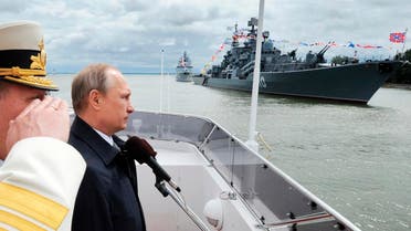 Russian President Vladimir Putin, second left, reviews a Navy parade in Baltiisk, western Russia, Sunday, July 26, 2015 during celebrations for Russian Navy Day.  AP