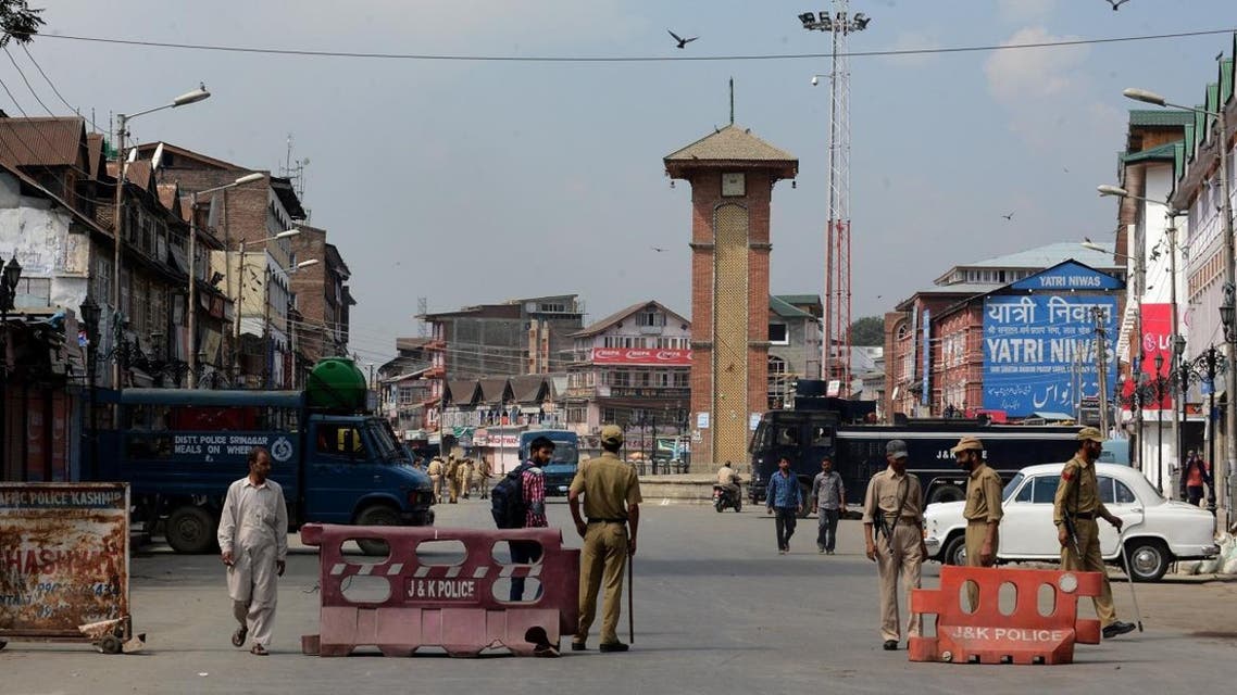 Indian policemen stand guard near a barricade in Srinagar on September 7, 2015