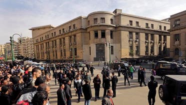 People gather the site of a bomb blast in front of the Egyptian High Court, in Cairo, Egypt, Monday, March 2, 2015. AP