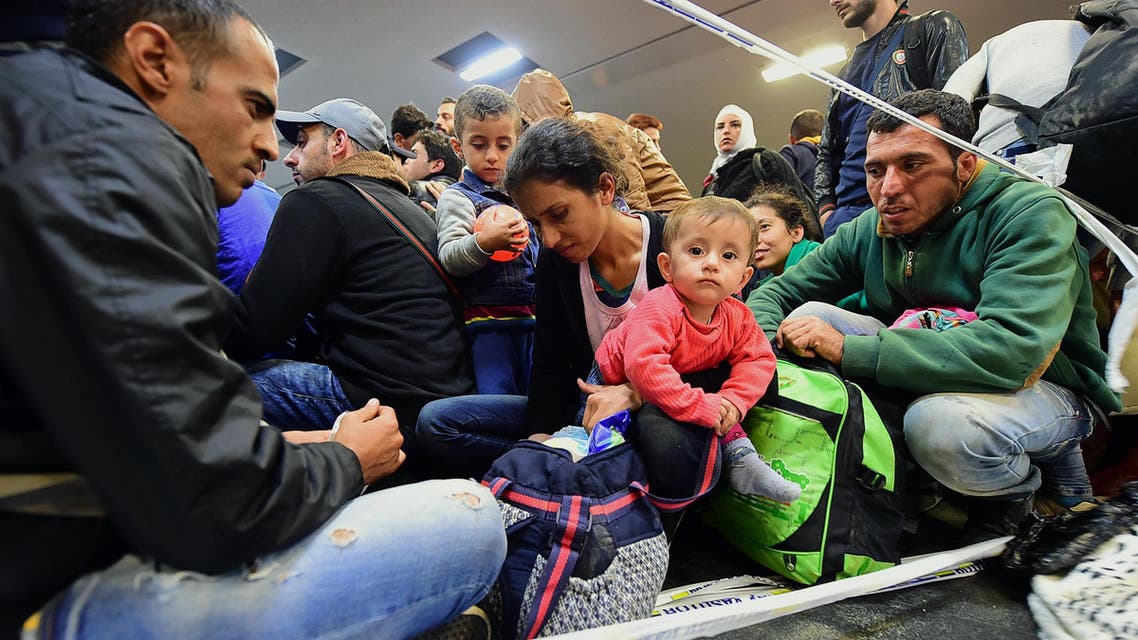 A refugee family waits to be allowed onto a train platform in the Hungarian capital of Budapest. (AFP)