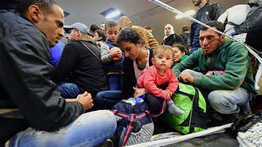 A refugee family waits to be allowed onto a train platform in the Hungarian capital of Budapest. (AFP)