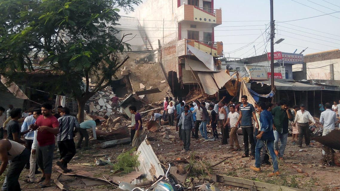 People gather around the site of an explosion at a restaurant in Jhabua district in the central Indian state of Madhya Pradesh on September 12, 2015.