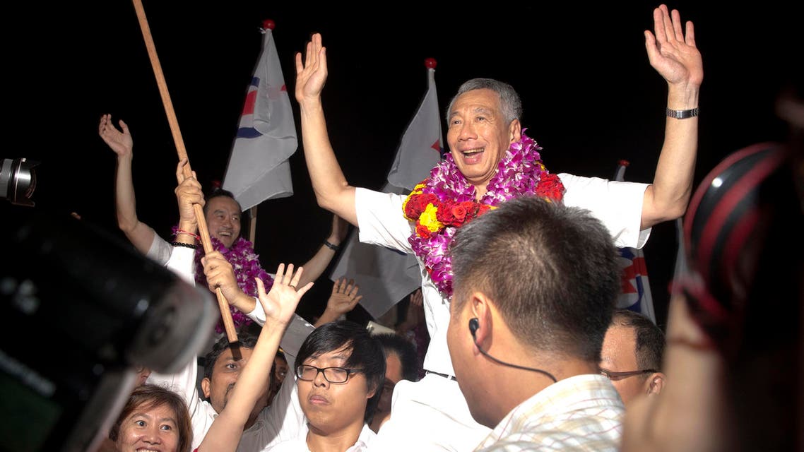 Singapore's Prime Minister Lee Hsien Loong of the ruling People's Action Party celebrate a win in his constituency in Singapore, Saturday, Sept. 12, 2015. (AP)