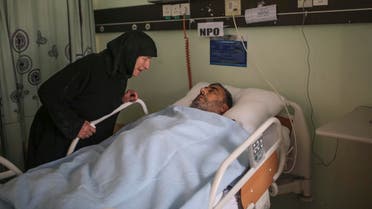 A Syrian pilgrim cries next to her husband who was injured after a construction crane collapsed at the Grand Mosque in the Muslim holy city of Mecca, while visiting him in Al Nour specialist hospital, one of the main hospitals where victims of the collapse were transferred in Mecca, Saudi Arabia, Sunday, Sept. 13, 2015. (A