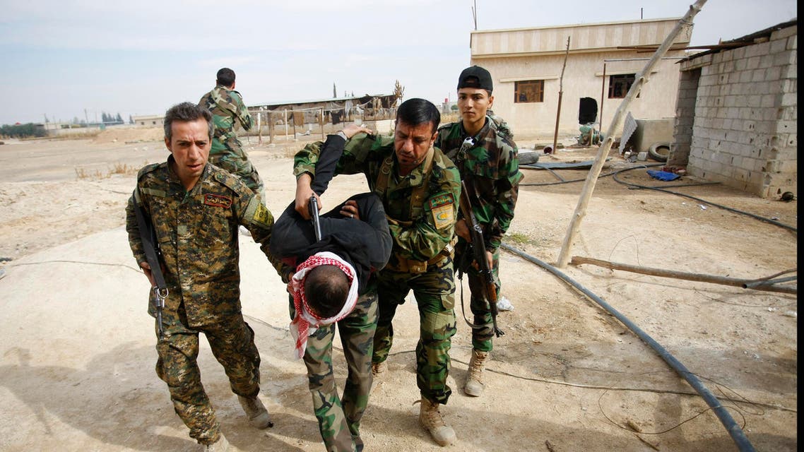 FILE - In this Friday, Nov. 22, 2013 file photo, Iraqi and Lebanese Shiite fighters from a group called the Hussein Brigade arrest a member of the Sunni-dominated Free Syrian Army in the town of Hatita, in the countryside of Damascus, Syria. IFrom the three-year-old boy who washed ashore on a Turkish beach to the 71 migrants who suffocated in a truck in Austria to the daily scenes of chaos unfolding in European cities as governments try to halt a human tide heading north. There is no let up to the horrors that Syria’s civil war keeps producing. Syria’s brutal conflict, now in its fifth year, has touched off the greatest humanitarian crisis of our time. About 250,000 people have been killed and more than one million wounded since March 2011, according to U.N. officials. (AP Photo/Jaber al-Helo, File)