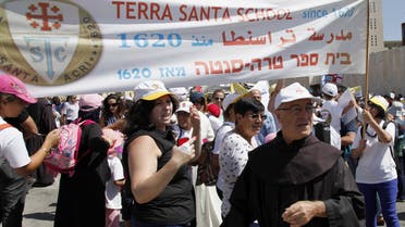 Arab Israeli Christians hold signs during a demonstration in front of the prime minister's office in Jerusalem, Sunday, Sept. 6, 2015. AP 