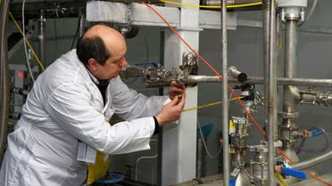 An unidentified International Atomic Energy Agency (IAEA) inspector cuts the connections between the twin cascades for 20 percent uranium enrichment at the Natanz facility, some 200 miles (322 kilometers) south of the capital Tehran,