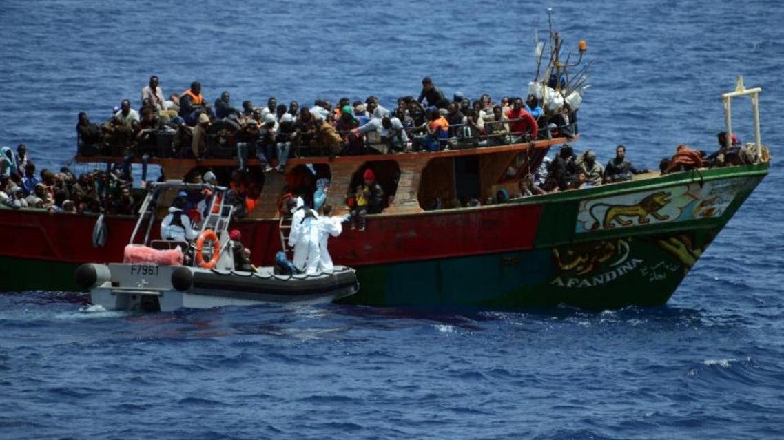 A French Navy patrol ship rescues migrants aboard a fishing boat in the Mediterranean Sea, on May 20, 2015 (AFP)