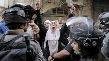 Israeli policemen prevent Palestinian women from entering the compound which houses al-Aqsa mosque. (Reuters)