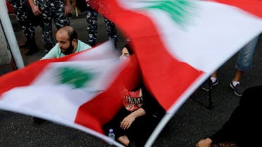Lebanese activists wave national flags and shout slogans outside the interior ministry during a sit-in demanding the release of two protesters who were arrested on Sept. 3. (File photo: AP)