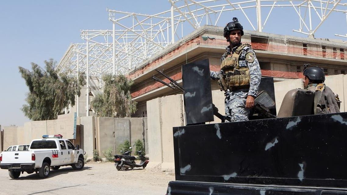 Iraqi security forces guard the entrance to a sports complex being built by a Turkish construction company, in the Shiite district of Sadr City, Baghdad, Iraq, Wednesday, Sept. 2, 2015. AP