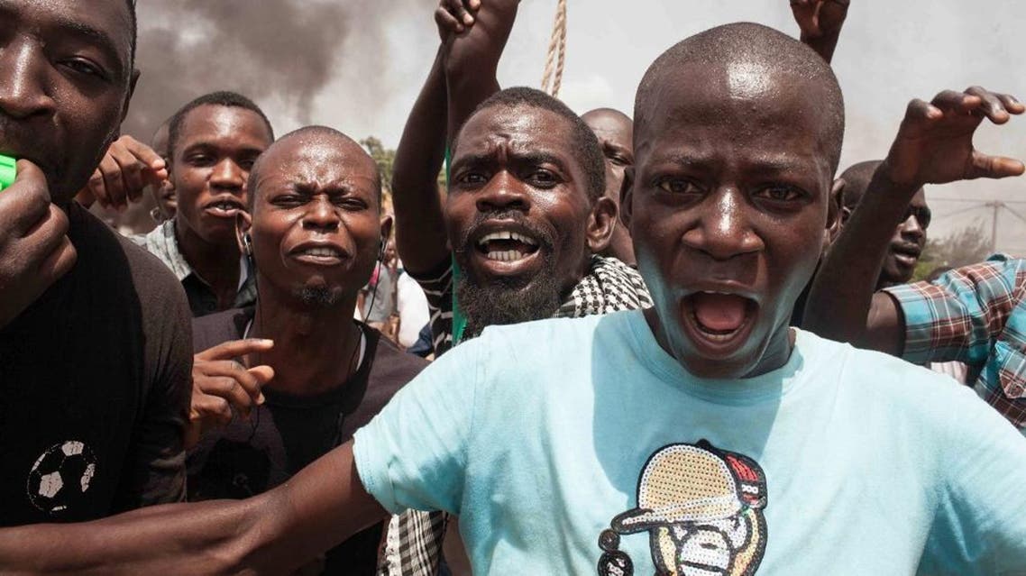 Burkina Faso protestors shout out as they take to the streets in the city of Ouagadougou, Burkina Faso, Thursday, Sept. 17, 2015. While gunfire rang out in the streets, Burkina Faso’s military took to the airwaves Thursday to declare it now controls the West African country, confirming that a coup had taken place just weeks before elections. (AP Photo/Theo Renaut)