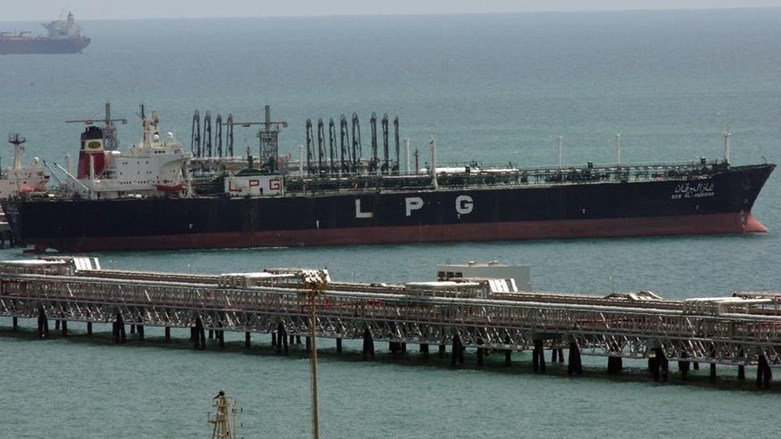 In this June 2008 file image a tanker ship from KOTC (Kuwait Oil Tankers Co) loads liquefied petroleum gas at Ahmadi pier, 40 kms south of Kuwait City . A Kuwaiti court has convicted four former officials of a state-owned oil tanker company of embezzling over US$100 million and sentenced them to up to 55 years in jail, according to a court document obtained Monday June 29, 2009. (AP File Photo/Gustavo Ferrari,File)