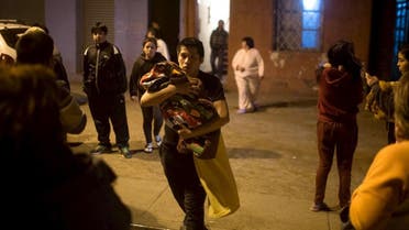 Residents wait on a street outside their houses after an earthquake hit Chile's central zone, in Santiago
